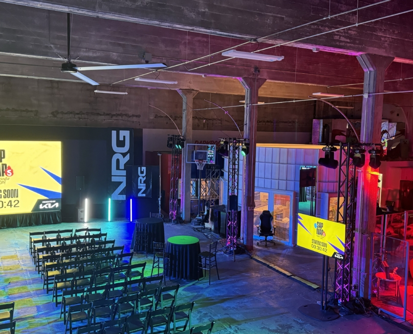 Warehouse event with stage, screens and colored lighting